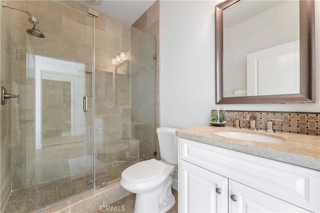 full bath featuring a shower stall, toilet, and vanity