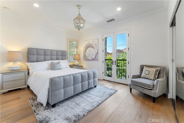 bedroom with ornamental molding, access to outside, visible vents, and wood finished floors