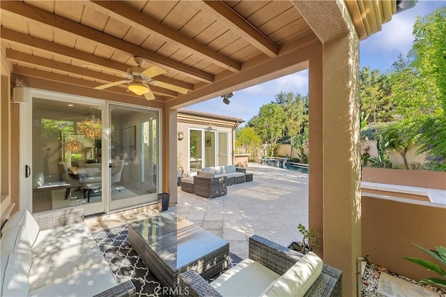 view of patio with an outdoor pool, fence, outdoor lounge area, and a ceiling fan