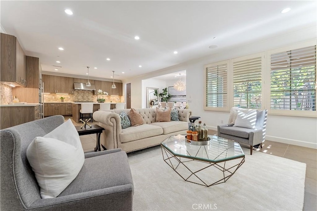 living room featuring light tile patterned floors, baseboards, and recessed lighting