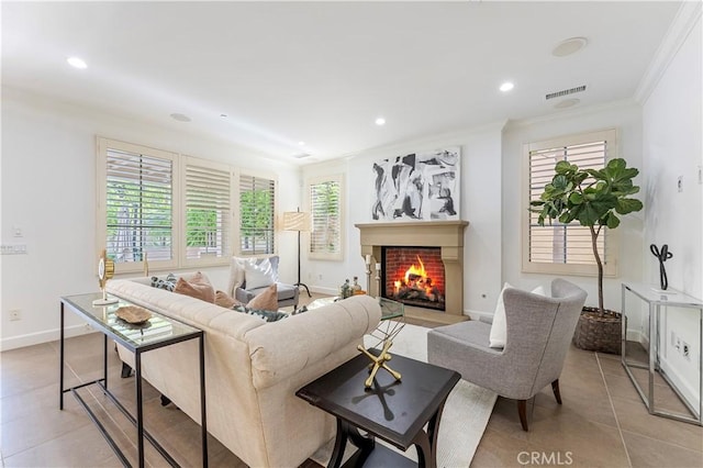 living room featuring a warm lit fireplace, light tile patterned floors, visible vents, and recessed lighting