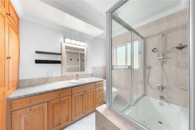 full bathroom with ornamental molding, vanity, shower / bath combination with glass door, and toilet