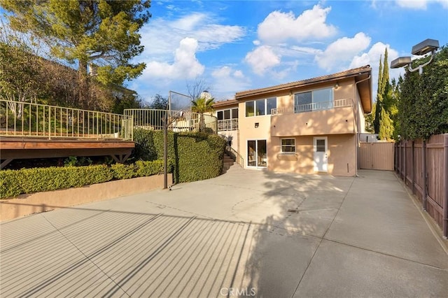 back of house with a patio and a balcony