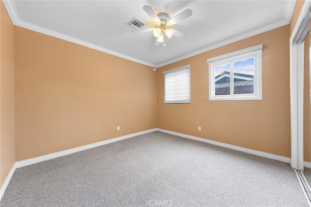 empty room featuring carpet, ceiling fan, and ornamental molding