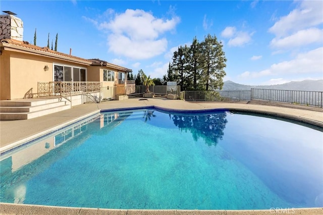 view of pool featuring a mountain view and a patio area