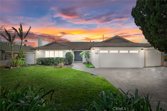 view of front of property with a yard and a garage