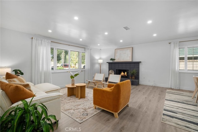 living room featuring plenty of natural light and light hardwood / wood-style flooring