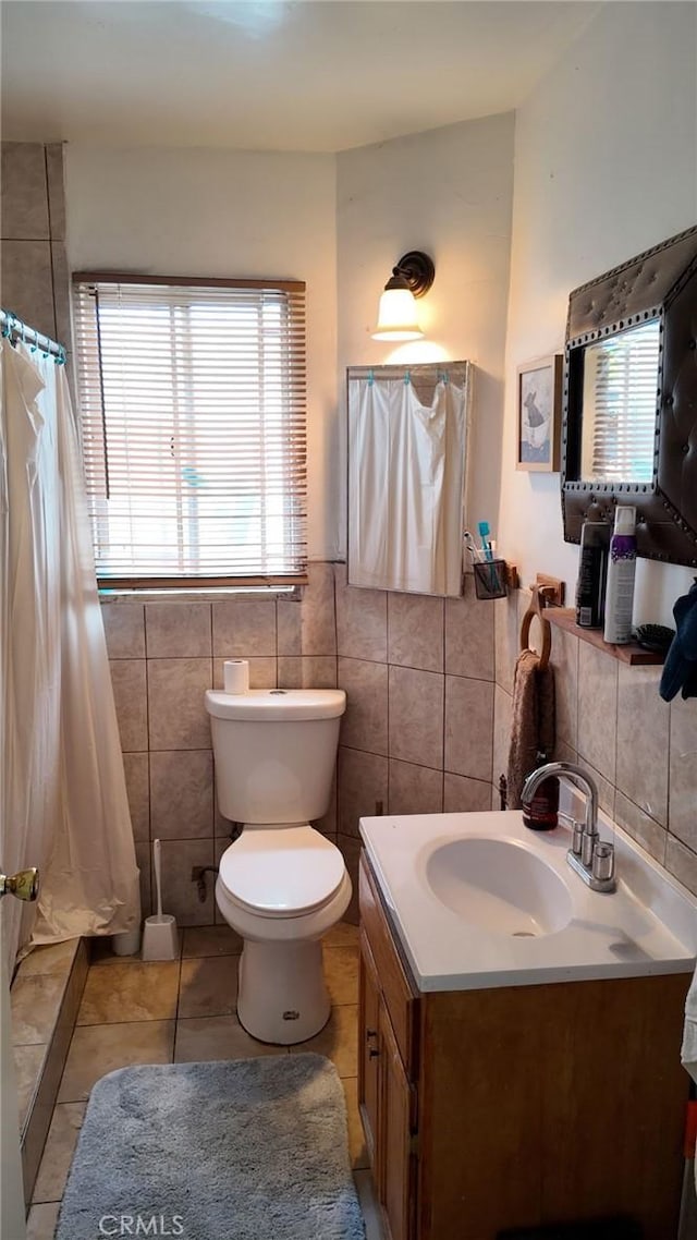 10813 State St, Lynwood, CA 90262 - bathroom featuring tile walls, tile patterned floors, vanity, a shower with curtain, and a wainscoted wall