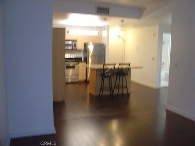 dining space featuring dark wood-style floors, baseboards, and visible vents