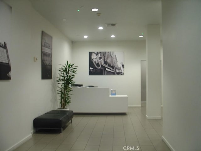 hall with baseboards and recessed lighting