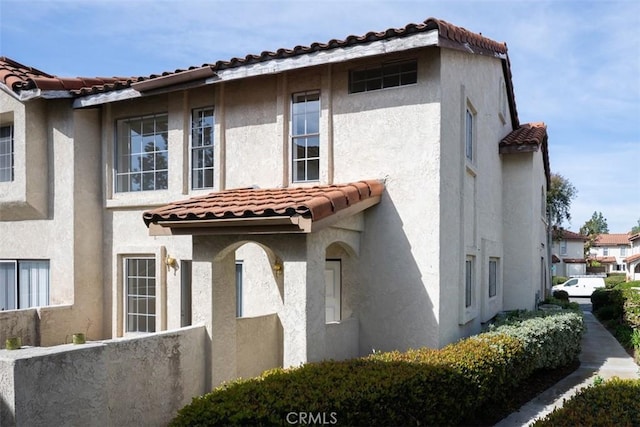 view of front of property featuring fence and stucco siding