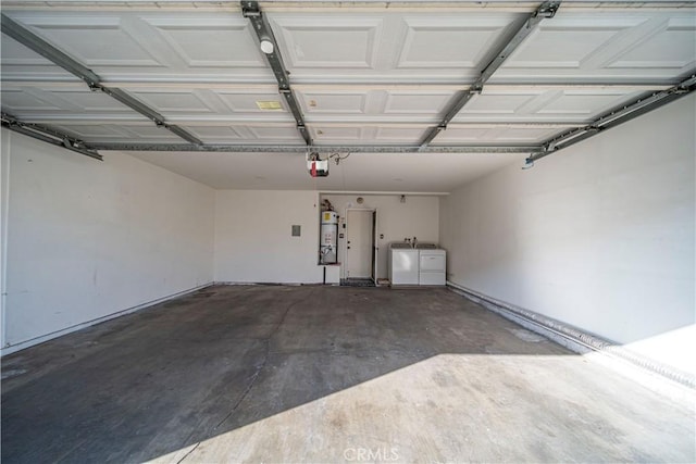 garage with a garage door opener, secured water heater, and washer and clothes dryer