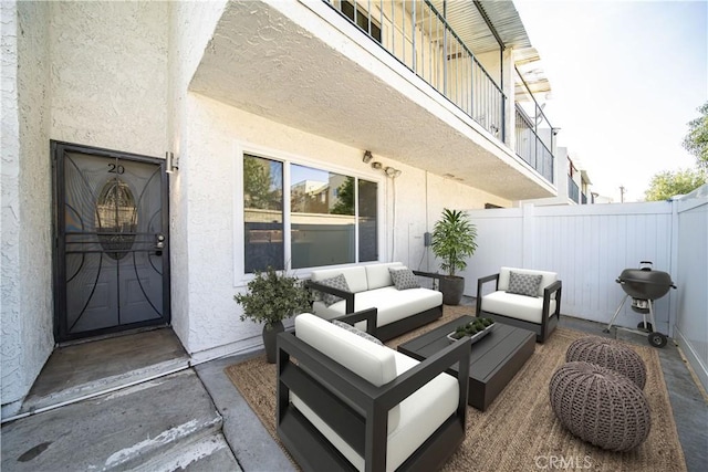 view of patio / terrace featuring outdoor lounge area, a grill, a balcony, and fence