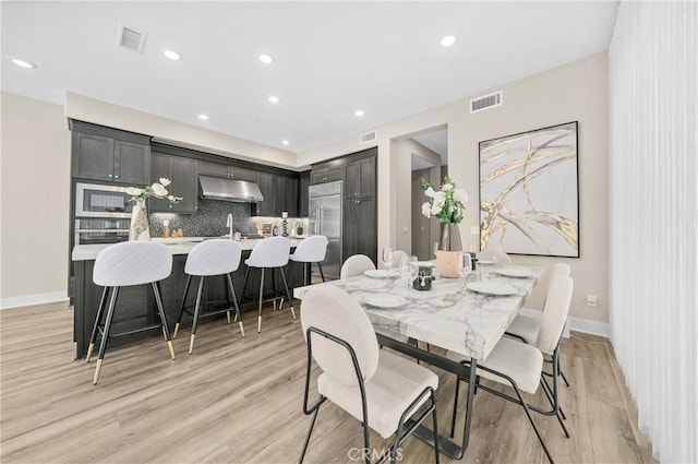 dining area featuring light wood-type flooring, visible vents, and recessed lighting