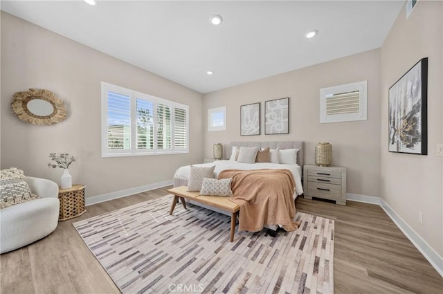 bedroom with recessed lighting, baseboards, and wood finished floors