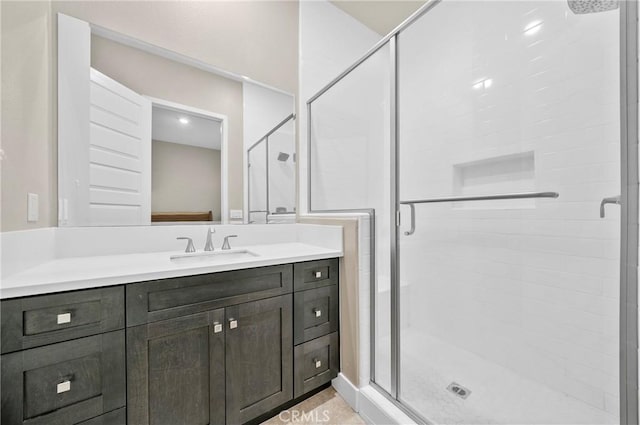 full bathroom with a shower stall and vanity