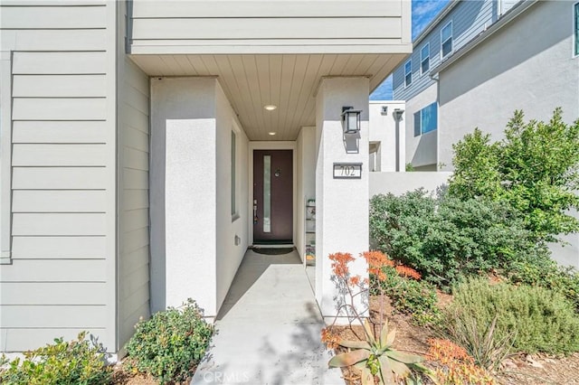 entrance to property featuring stucco siding