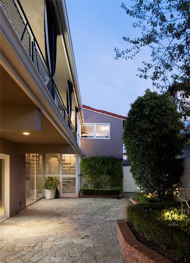 view of property exterior with a patio area and stucco siding