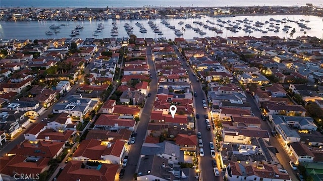 drone / aerial view with a residential view and a water view