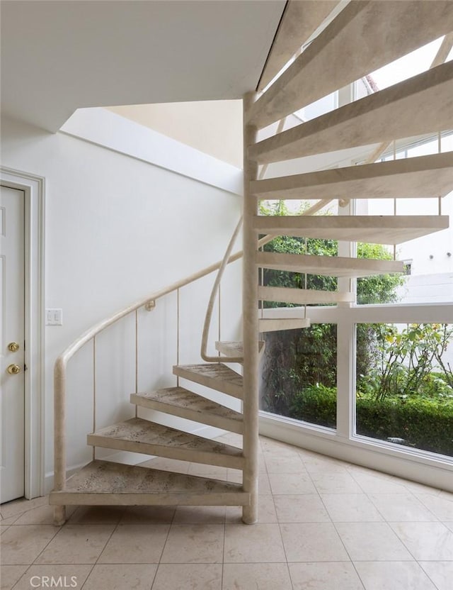 stairway with tile patterned flooring