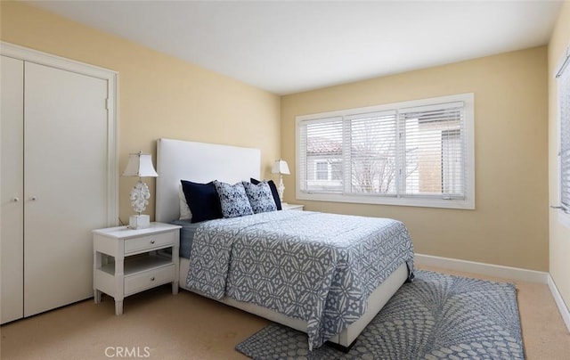 bedroom featuring light carpet and baseboards