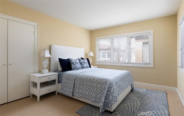 bedroom with baseboards and carpet