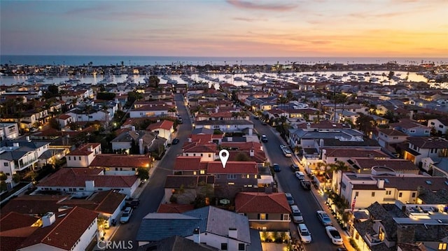 birds eye view of property featuring a water view and a residential view