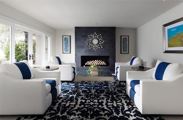 living area with carpet flooring and a fireplace