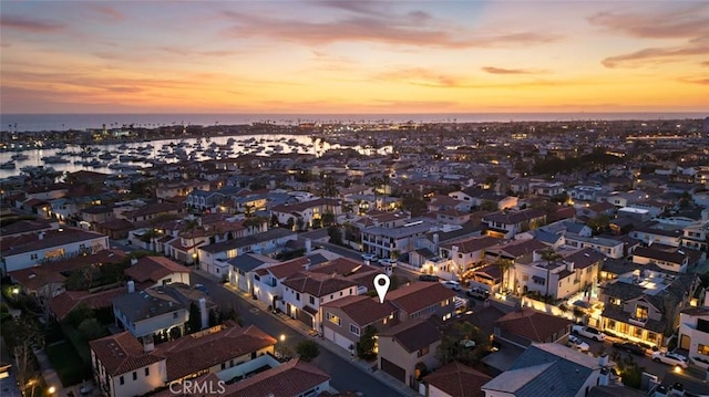aerial view at dusk featuring a residential view