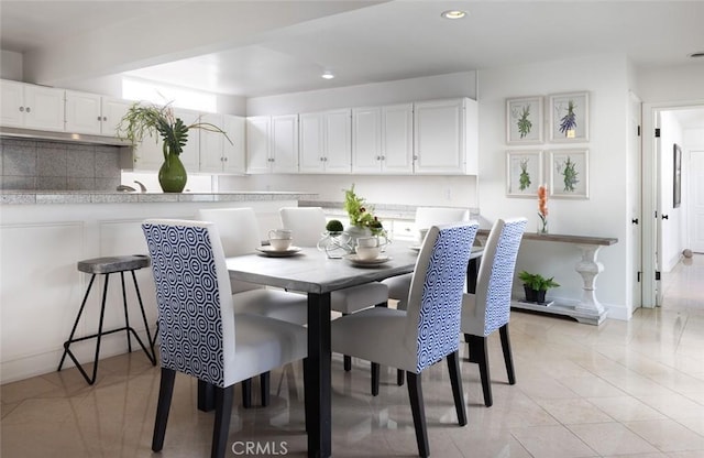 dining area with recessed lighting and baseboards