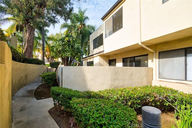 view of home's exterior featuring fence and stucco siding