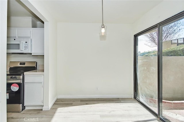 dining space featuring light wood-type flooring