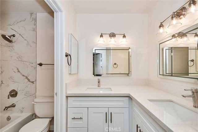 full bathroom with toilet, vanity, and shower / washtub combination