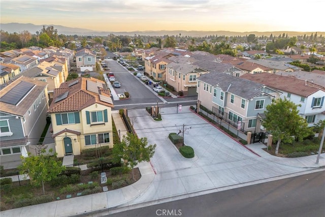 aerial view at dusk featuring a residential view