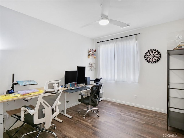 office space with dark wood-style floors, ceiling fan, and baseboards