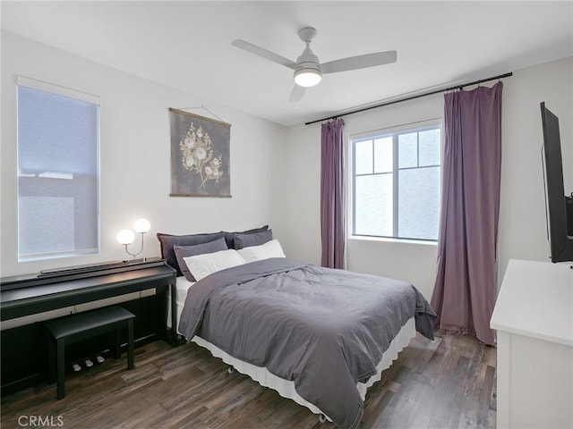 bedroom with dark wood-style floors and ceiling fan