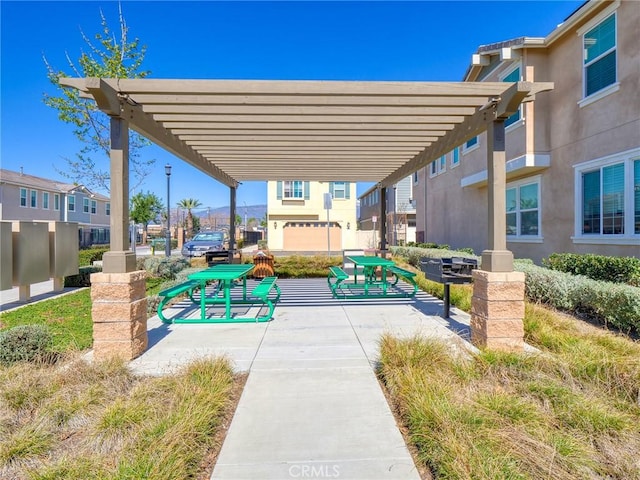 view of community featuring a residential view and a pergola