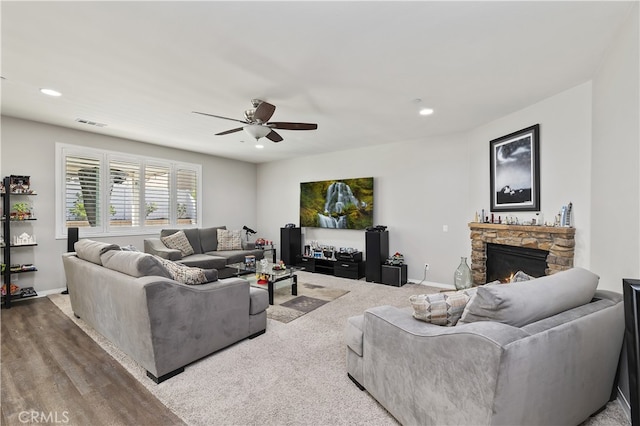 living room with baseboards, a fireplace, visible vents, and recessed lighting