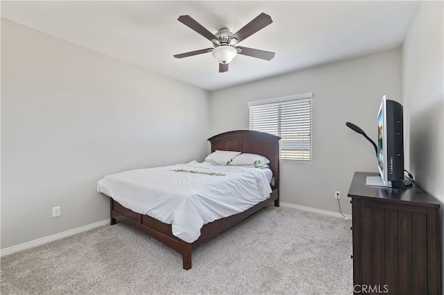 bedroom with ceiling fan, baseboards, and light colored carpet