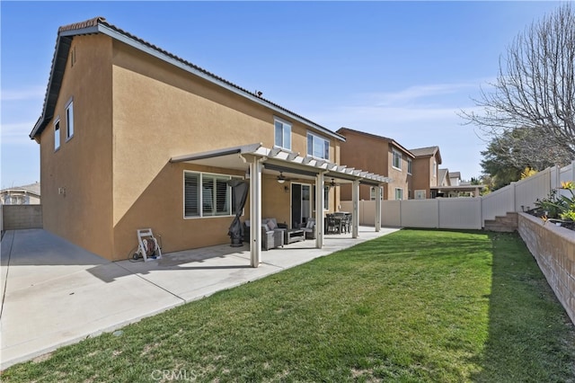 back of house with a patio, a lawn, a fenced backyard, and stucco siding