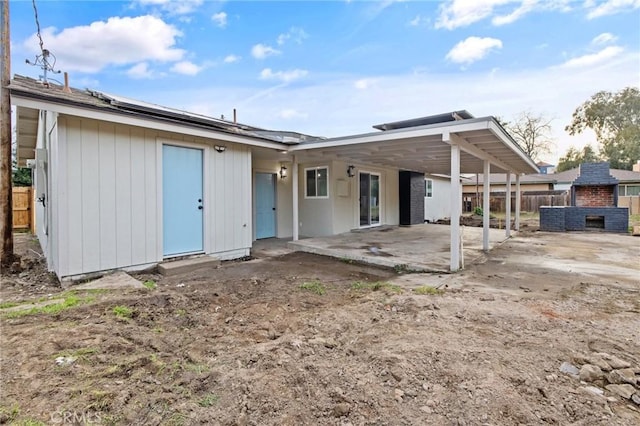 back of property with a patio area and fence