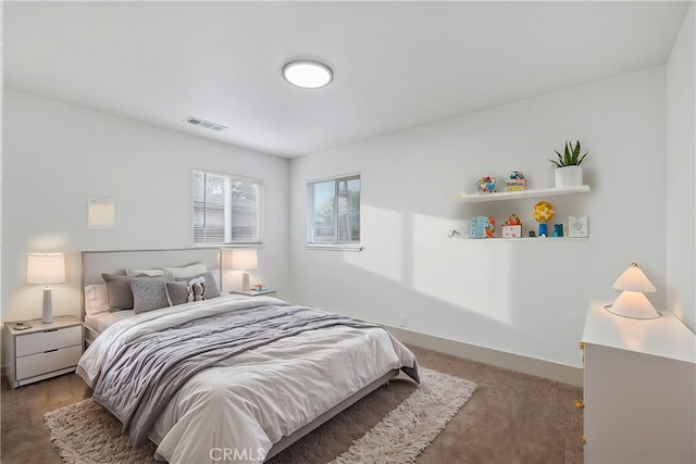 carpeted bedroom with baseboards and visible vents