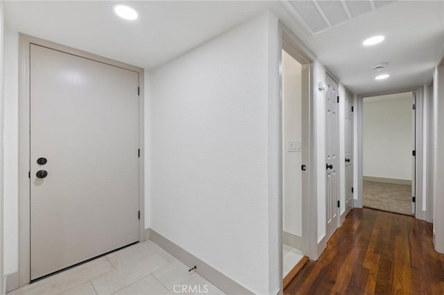 hallway with recessed lighting, baseboards, wood finished floors, and visible vents