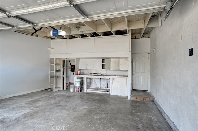 garage featuring baseboards and a garage door opener