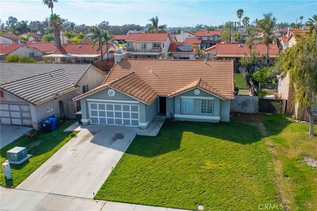 view of front of house featuring concrete driveway, a residential view, a front yard, and fence