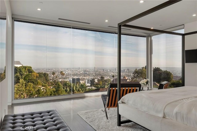 bedroom featuring expansive windows, recessed lighting, and multiple windows