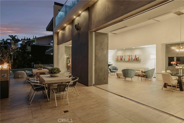 patio terrace at dusk featuring outdoor dining area