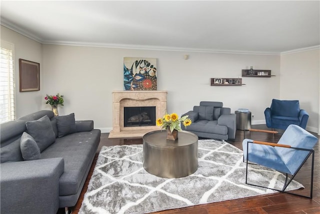 living room featuring dark wood-style floors, baseboards, a premium fireplace, and ornamental molding