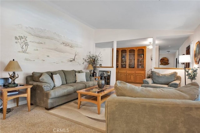 living area featuring lofted ceiling and light colored carpet