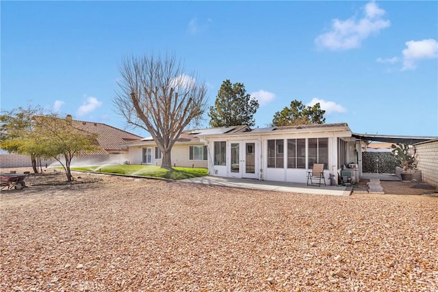 back of house featuring french doors, a patio, and a sunroom